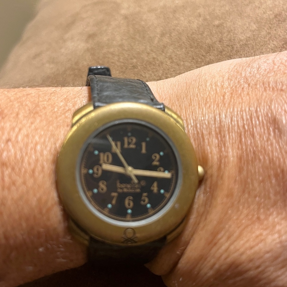 Vintage Benetton watch by Bulova. Black leather strap is showing signs of age.